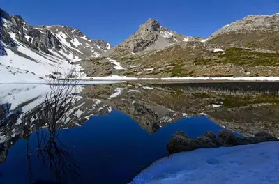 a reflection of a mountain in a body of water at Posada El Rincón de Babia in La Cueta
