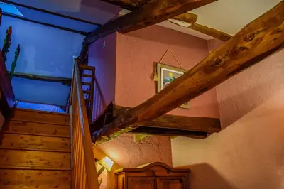 a staircase in a house with a blue ceiling at Posada El Rincón de Babia in La Cueta