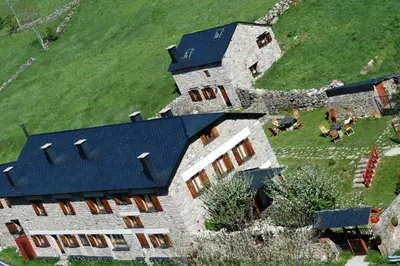 an aerial view of a large house with a blue roof at Posada El Rincón de Babia in La Cueta