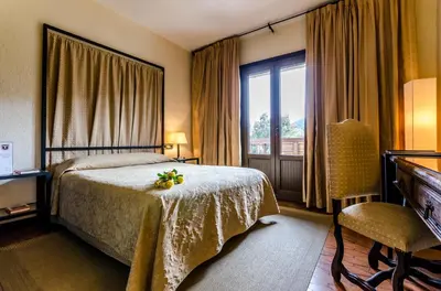 a hotel room with a bed and a window at Hotel Temple Ponferrada in Ponferrada