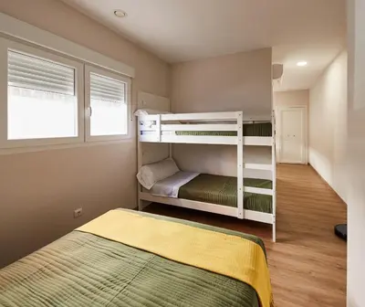 a bedroom with two bunk beds and a bed at A Estreliña in Sigüeiro