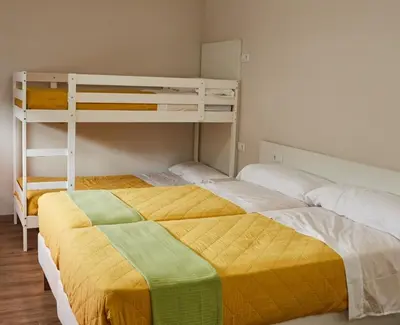 a bedroom with two bunk beds and a ladder at A Estreliña in Sigüeiro