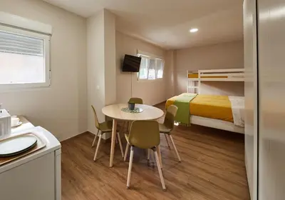 a small room with a table and a bed at A Estreliña in Sigüeiro
