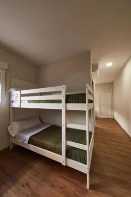 a bedroom with two bunk beds in a room at A Estreliña in Sigüeiro