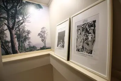 a shelf with three framed photographs in a room at Hotel Alda San Carlos in Santiago de Compostela