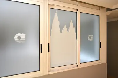 a sliding glass door with a reflection of a castle at Hotel Alda San Carlos in Santiago de Compostela