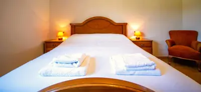 a bedroom with a bed with towels on it at Casa Olivar El Mandarino in Orazo