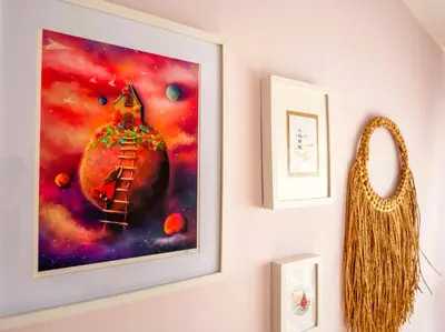 a painting hanging on a wall next to a mirror at Casa Olivar El Mandarino in Orazo