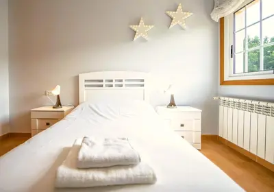 a white bedroom with stars on the wall at Casa Olivar El Mandarino in Orazo