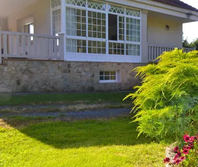 a house with a large window and a porch at Casa Olivar El Mandarino in Orazo