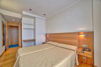 a bedroom with a large bed in a room at PR Rosa Rosae in Santiago de Compostela
