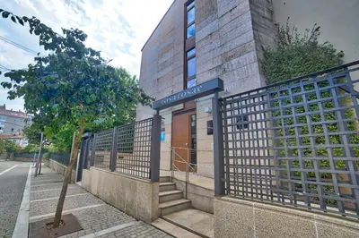 a building with a gate in front of a building at PR Rosa Rosae in Santiago de Compostela