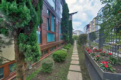 a sidewalk next to a building with flowers and plants at PR Rosa Rosae in Santiago de Compostela