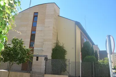 a building with a fence in front of it at PR Rosa Rosae in Santiago de Compostela