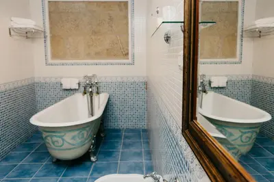 a bathroom with a tub and a toilet and a bath tub at Pazo Almuzara in Boborás
