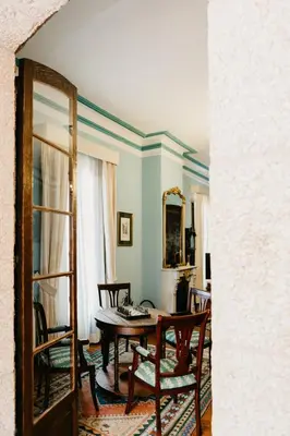 a living room with a table and chairs and a mirror at Pazo Almuzara in Boborás