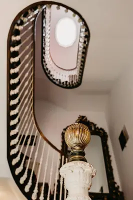 a mirror sitting on the wall next to a vase at Pazo Almuzara in Boborás
