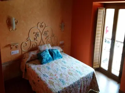 a bedroom with a bed with blue pillows on it at House - 4 Bedrooms with Pool - 4093 in A Estrada