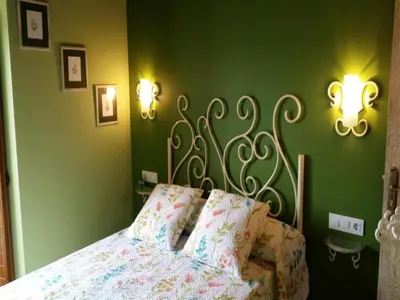 a bedroom with a bed with a metal headboard and lights at House - 4 Bedrooms with Pool - 4093 in A Estrada
