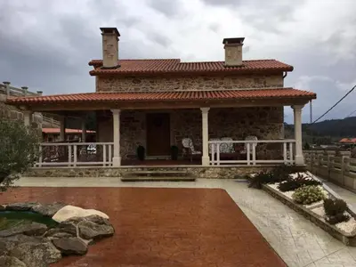 a small house with a roof on a patio at House - 4 Bedrooms with Pool - 4093 in A Estrada