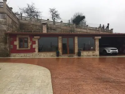 a building with a car parked under a bridge at House - 4 Bedrooms with Pool - 4093 in A Estrada