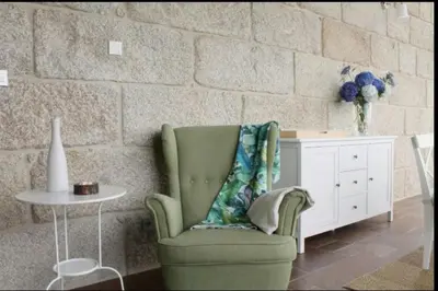 a living room with a green chair and a table at Villa - 5 Bedrooms with WiFi - 7841 in A Estrada