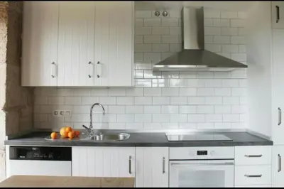 a white kitchen with a sink and a stove at Villa - 5 Bedrooms with WiFi - 7841 in A Estrada