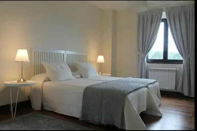 a bedroom with a bed with white sheets and a window at Villa - 5 Bedrooms with WiFi - 7841 in A Estrada