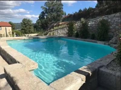 a swimming pool with blue water at Villa - 5 Bedrooms with WiFi - 7841 in A Estrada