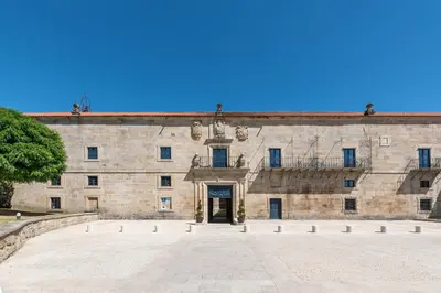 a large stone building with a door in it at Eurostars Monumento Monasterio de San Clodio Hotel in Leiro