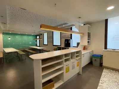 a kitchen with a counter and a dining room at Guiana Rooms & Suites in Ponferrada