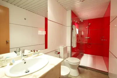 a bathroom with a sink and a toilet and a shower at Hotel Spa Congreso in Teo