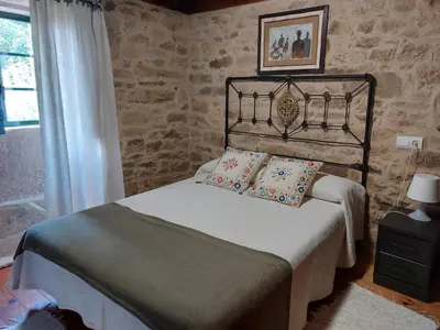 a bedroom with a bed with two pillows on it at Casas de Maragouzos in Silleda