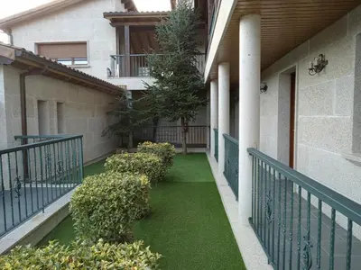 a balcony with green grass in a building at PENSIÓN RÚSTICA SANTA MARIÑA DA PONTE in Santa Marina del Puente