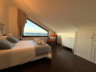 a bedroom with a large bed with a large window at A Marola By Oktheway in Puentedeume