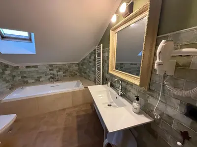 a bathroom with a sink and a tub and a mirror at A Marola By Oktheway in Puentedeume