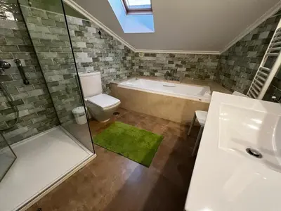 a bathroom with a tub and a toilet and a shower at A Marola By Oktheway in Puentedeume