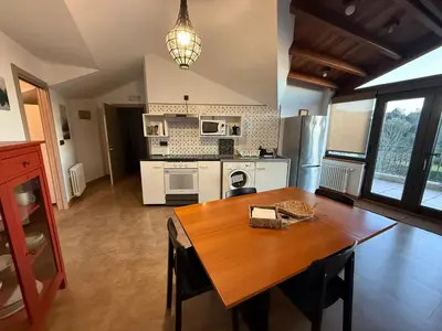 a kitchen with a wooden table and a dining room at A Marola By Oktheway in Puentedeume