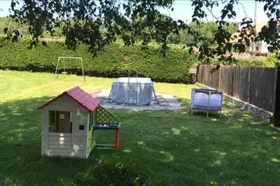 a yard with a dog house in the grass at Villacambote5 in Lalín