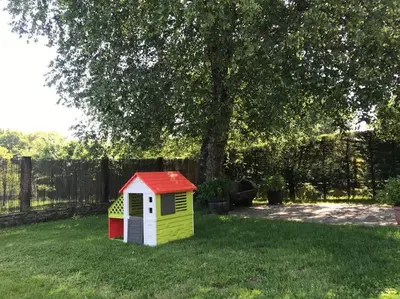 a small dog house in the grass near a tree at Villacambote5 in Lalín