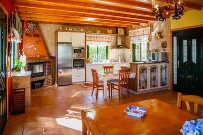 a kitchen with a table and a dining room at Villacambote5 in Lalín