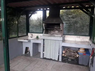 an outdoor kitchen with a stove and a sink at Villacambote5 in Lalín