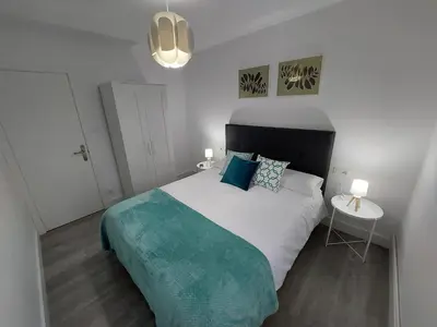 a bedroom with a large bed and a table at Acea Nova 3 in Monforte de Lemos