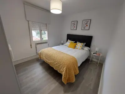 a bedroom with a large bed with yellow pillows at Acea Nova 3 in Monforte de Lemos