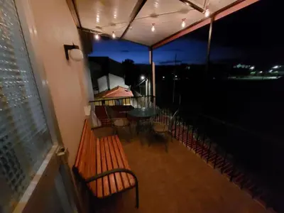 a balcony with a table and chairs at night at Acea Nova 3 in Monforte de Lemos