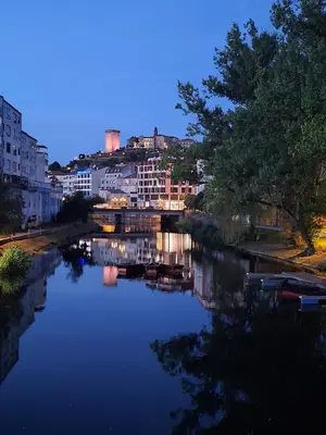 a view of a river at night with buildings at Acea Nova 3 in Monforte de Lemos