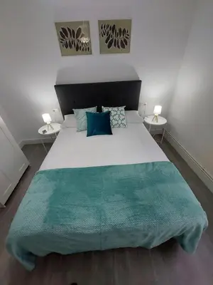 a bedroom with a large bed with two side tables at Acea Nova 3 in Monforte de Lemos