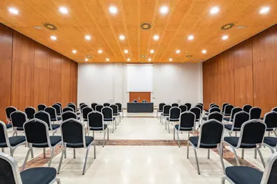 a conference room with chairs and a podium at Eurostars San Lazaro in Santiago de Compostela