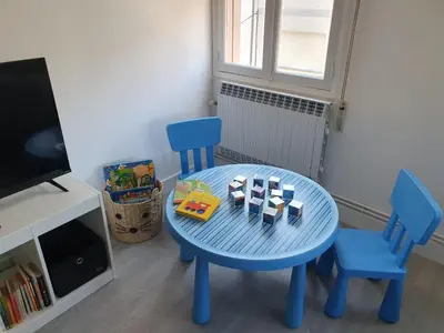 a blue table with two chairs and a table with a toy at Acea Nova 2 in Monforte de Lemos