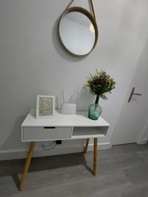a white table with a mirror and a vase with flowers at Acea Nova 2 in Monforte de Lemos